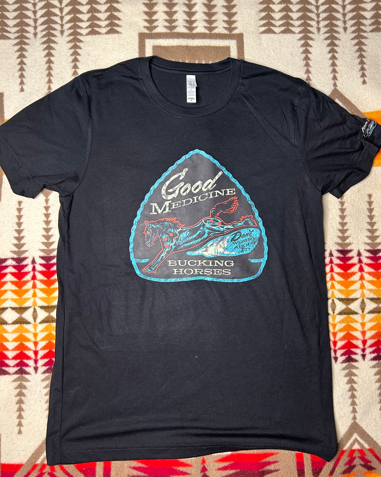 Good Medicine Bucking Horses “Distressed” Black Arrowhead Tee